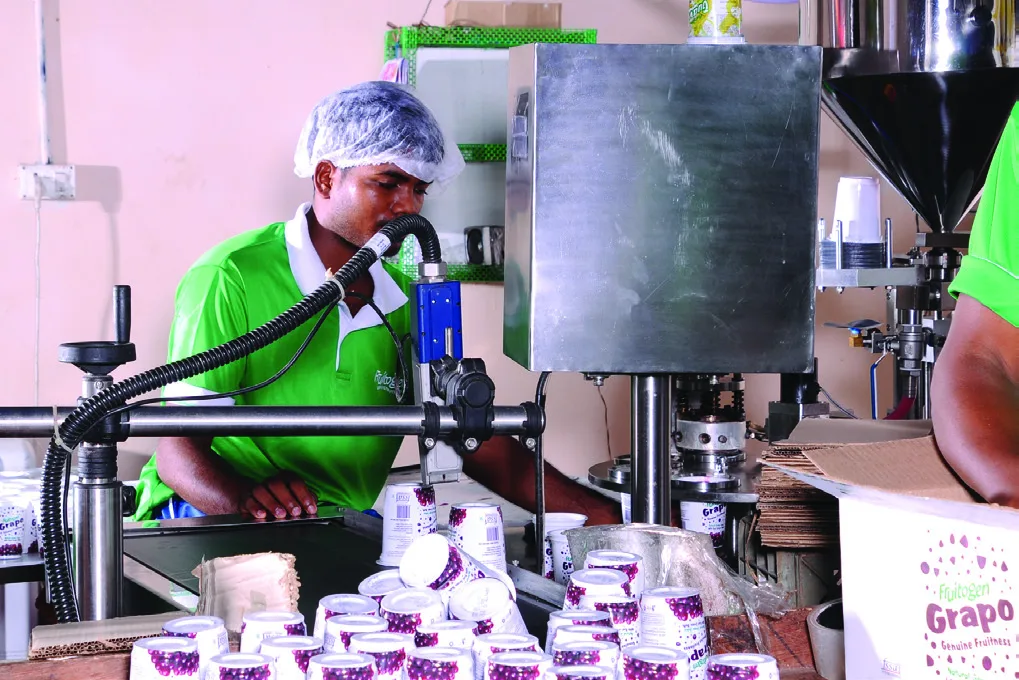 Fruitogen team filling Grapo juice cups on the production line